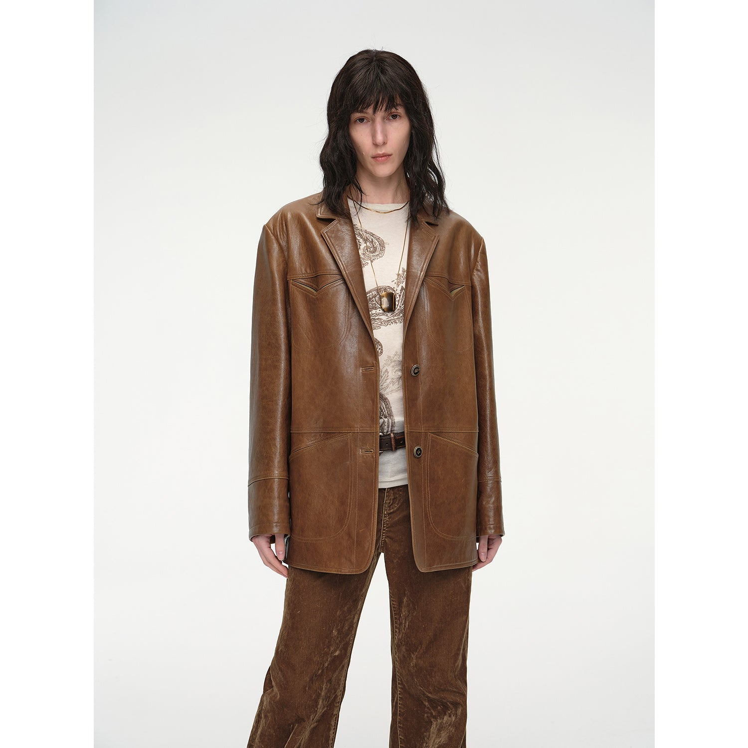 Person wearing a brown leather suit on a white background