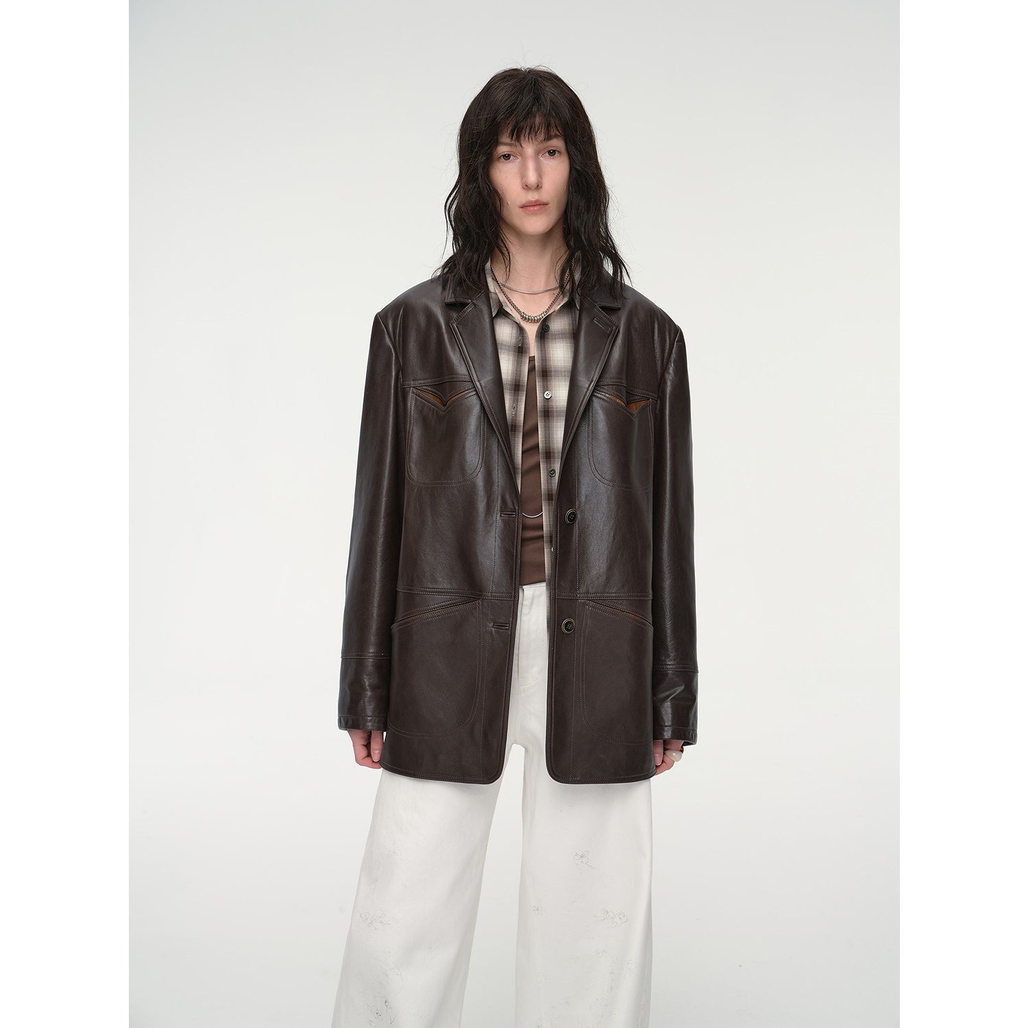 Person wearing a brown leather jacket on a white background