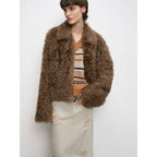 Woman wearing a brown fluffy jacket on a white background