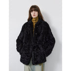 Person wearing a black fluffy coat against a white background