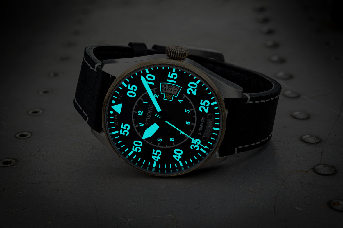 Watch with a glowing face on a dark background