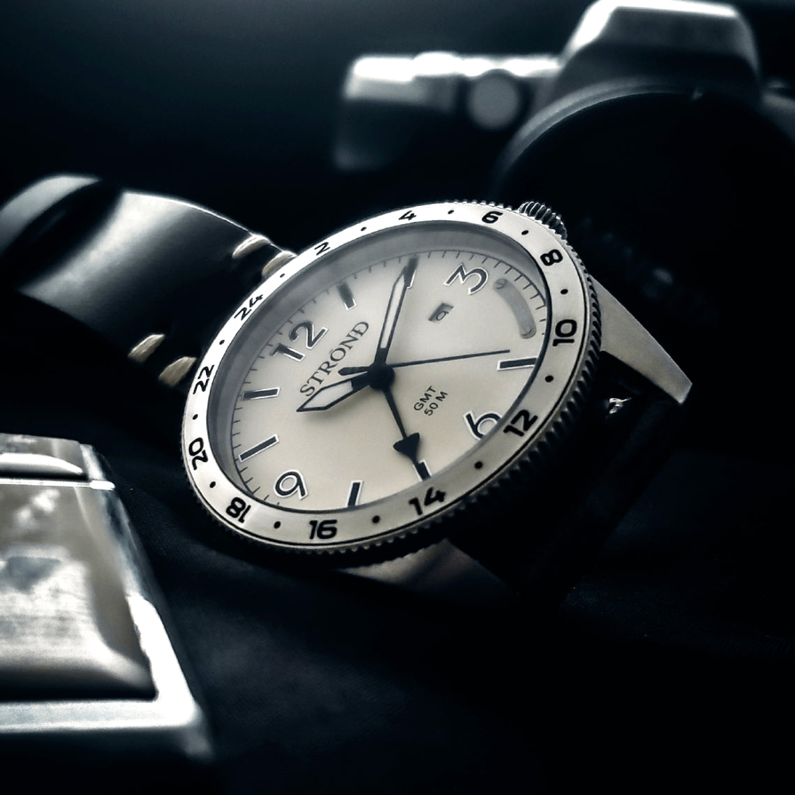 Straton wristwatch with black strap on a dark background