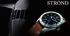 Watch with a dark face and brown strap on a black background, featuring the brand 'STRØND'.
