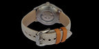 Watch with a beige strap featuring orange accents on a black background