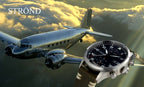 Vintage airplane flying above clouds with a watch in the foreground, featuring the brand 'STROND'.