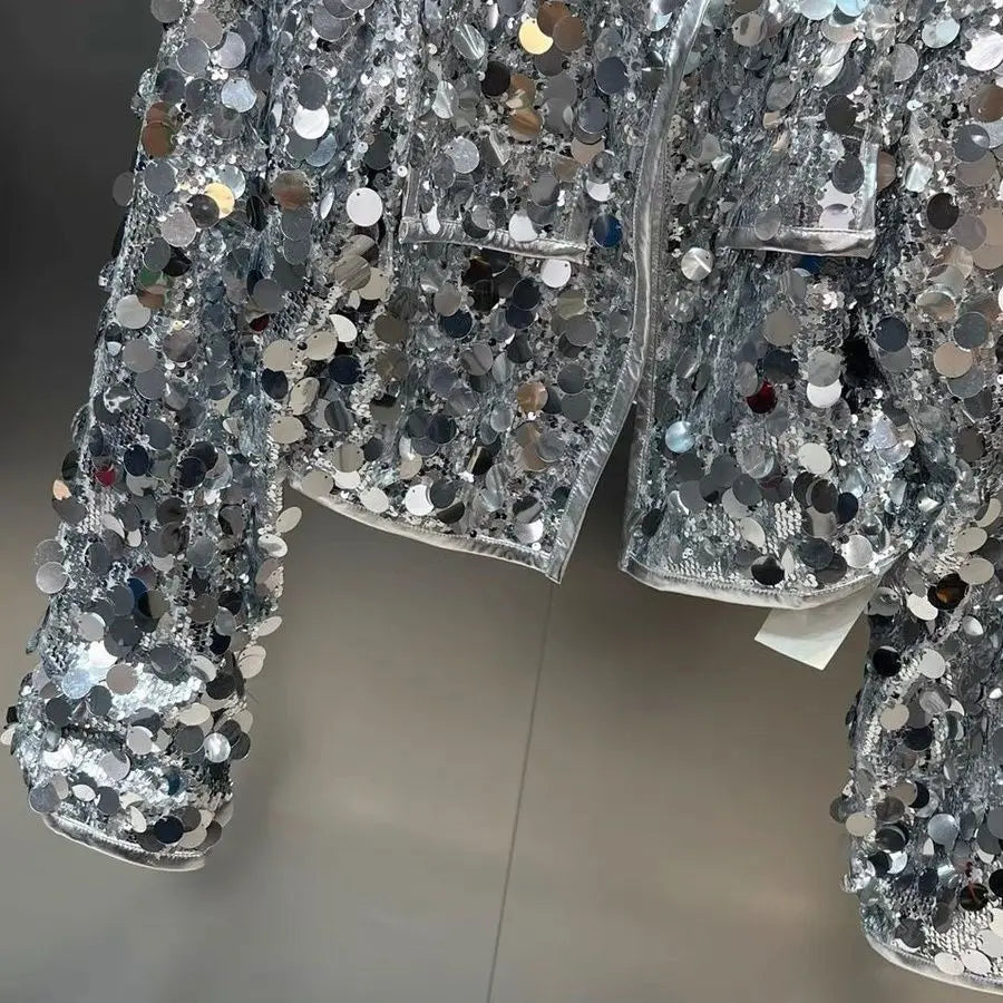 Silver sequin shorts on a mannequin against a neutral background