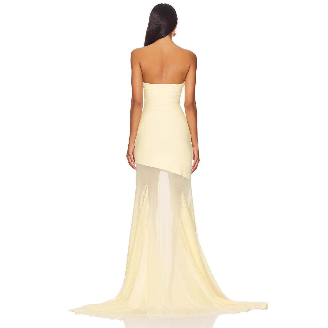 Woman wearing a strapless yellow evening gown on a white background