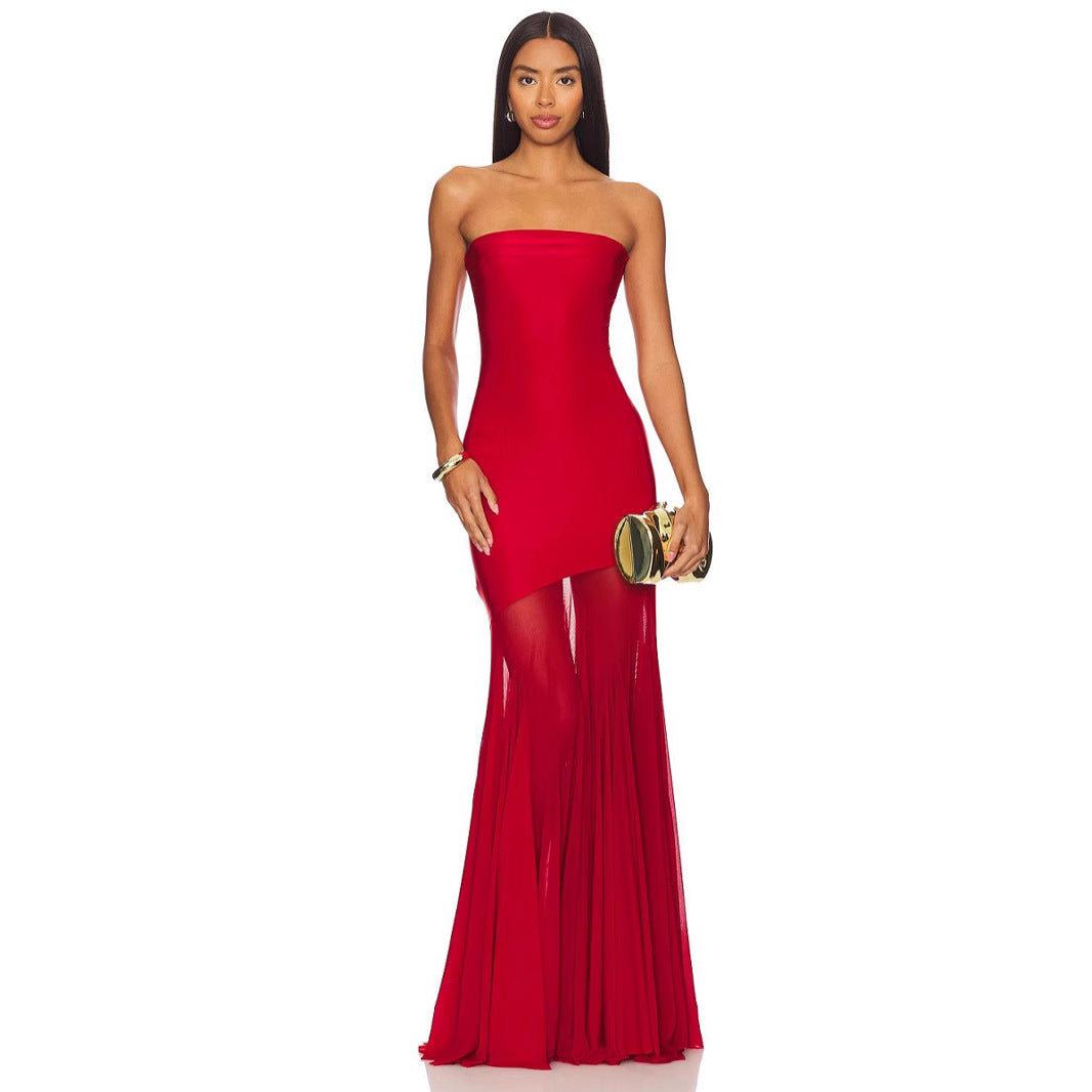 Woman wearing a strapless red evening gown on a white background