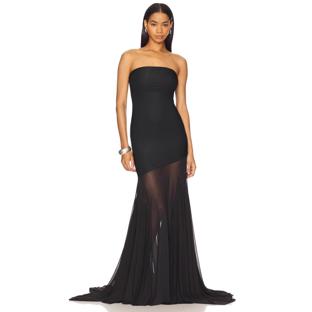 Black strapless gown with sheer overlay on a white background