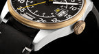 Close-up of a wristwatch with a detailed face on a black background