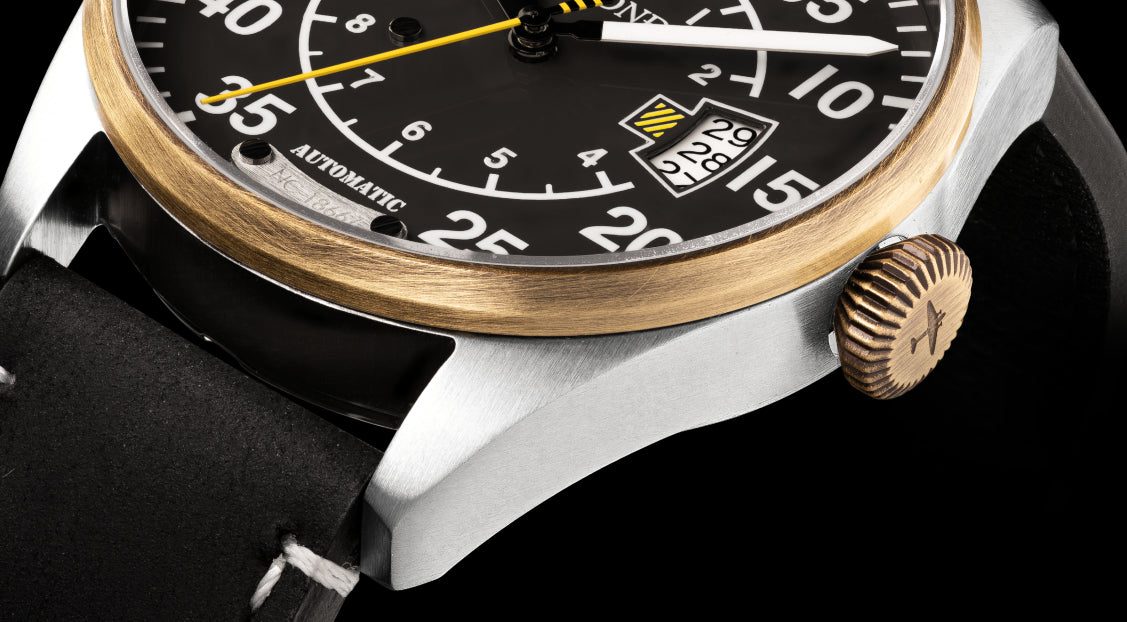 Close-up of a wristwatch with a detailed face on a black background