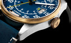 Close-up of a detailed wristwatch with a blue face and gold accents.