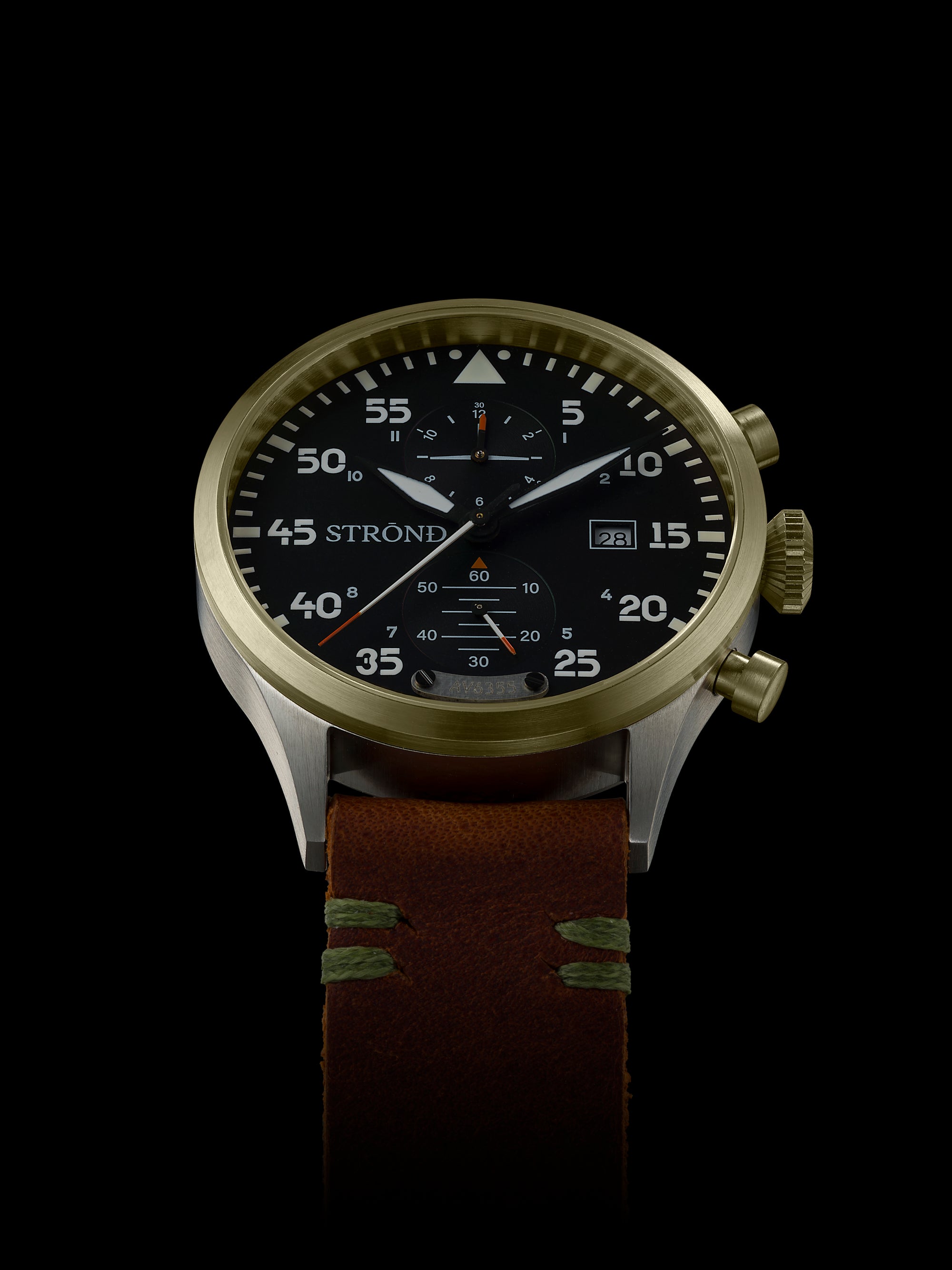 Wristwatch with a brown leather strap and gold case on a black background