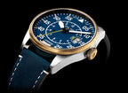 Watch with blue face and navy strap on a black background