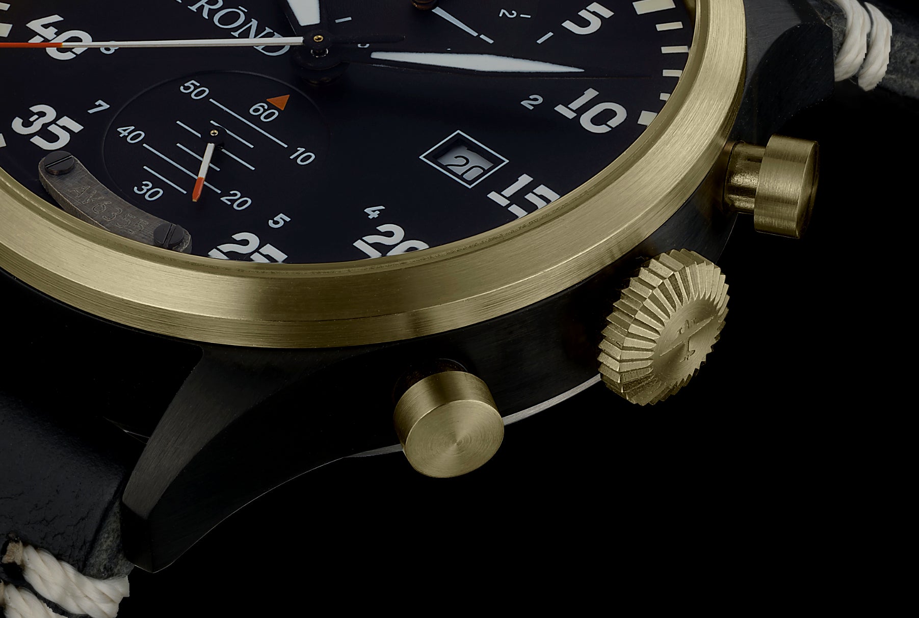 Close-up of a luxurious watch with gold and black design on a dark background