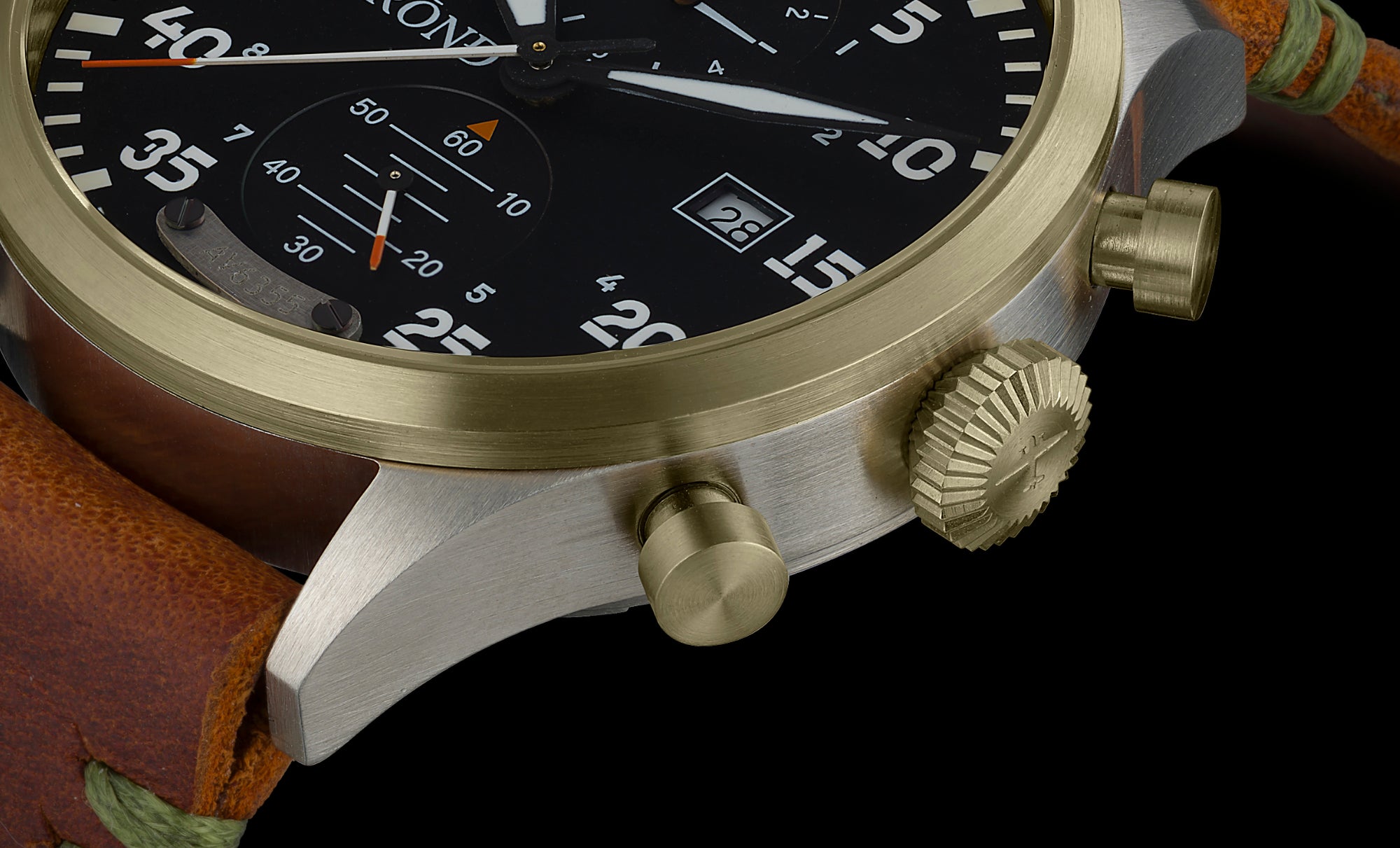 Close-up of a watch with a gold bezel and brown leather strap on a black background