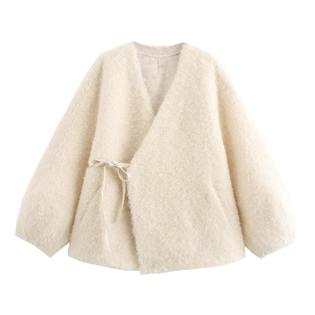 Beige cardigan with a tie detail on a white background