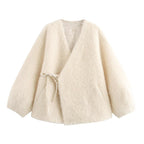 Beige cardigan with a tie detail on a white background