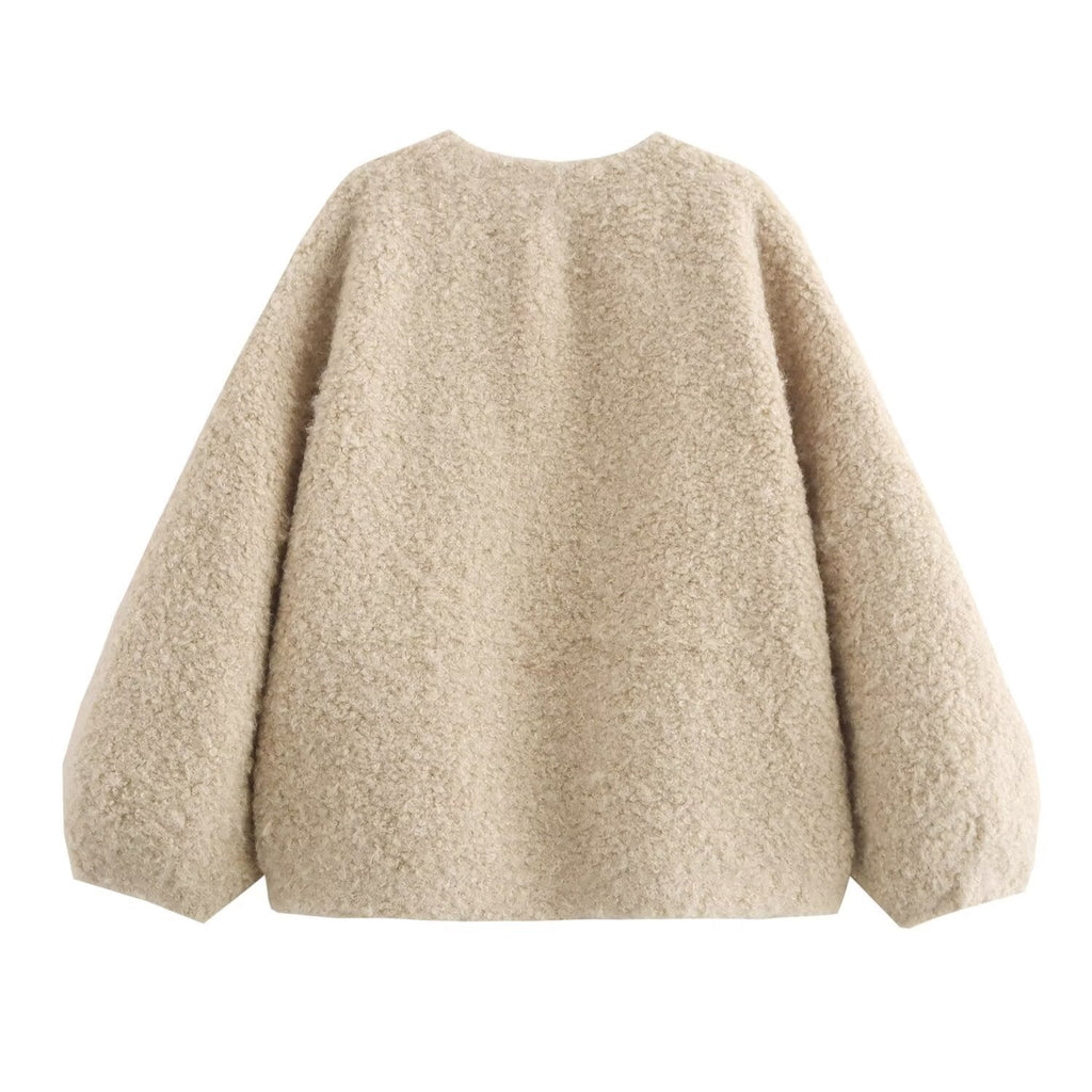 Beige fluffy sweater on a white background