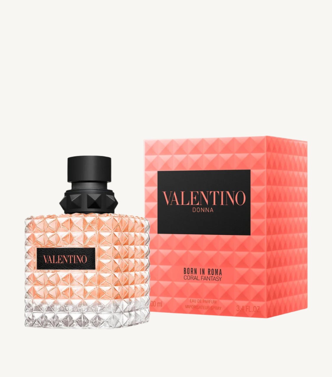 "Valentino Donna Born in Roma Coral Fantasy 3.4 oz Eau de Parfum Spray – a radiant floral-fruity fragrance for women with notes of juicy kiwi, rose, and musk, presented in a bold coral-colored studded bottle."