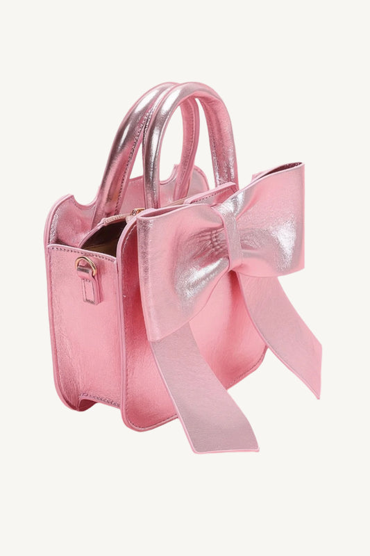 "Metallic top handle clutch with bow front – elegant yet playful accessory for stylish occasions."