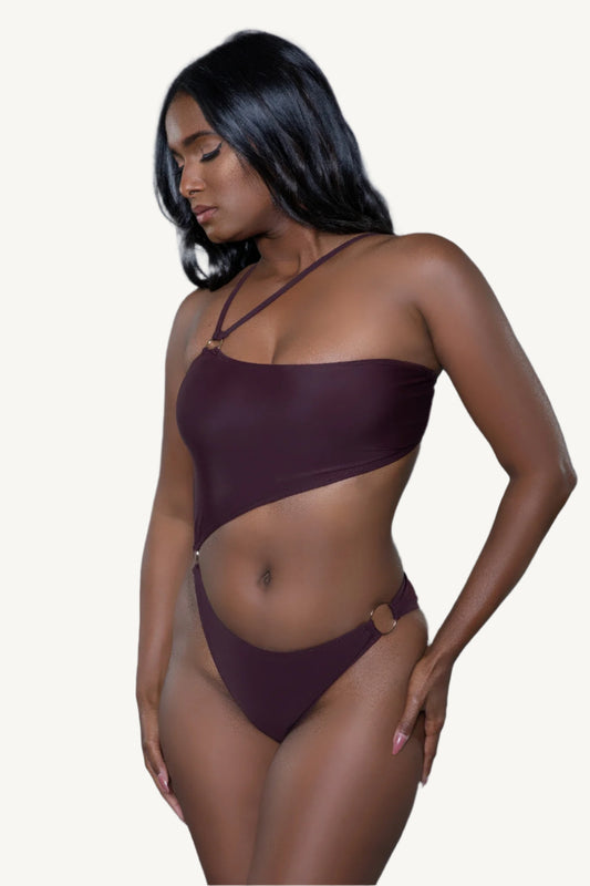 One-shoulder one-piece swimsuit with asymmetrical cutouts, strappy details, and metal ring accents – sleek, supportive, and designed for bold summer style.