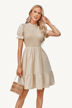 Solid puff sleeve dress with shirred bodice and ruffle hem, made from lightweight polyester – feminine, playful, and perfect for warm-weather days.