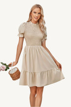 Solid puff sleeve dress with shirred bodice and ruffle hem, made from lightweight polyester – feminine, playful, and perfect for warm-weather days.