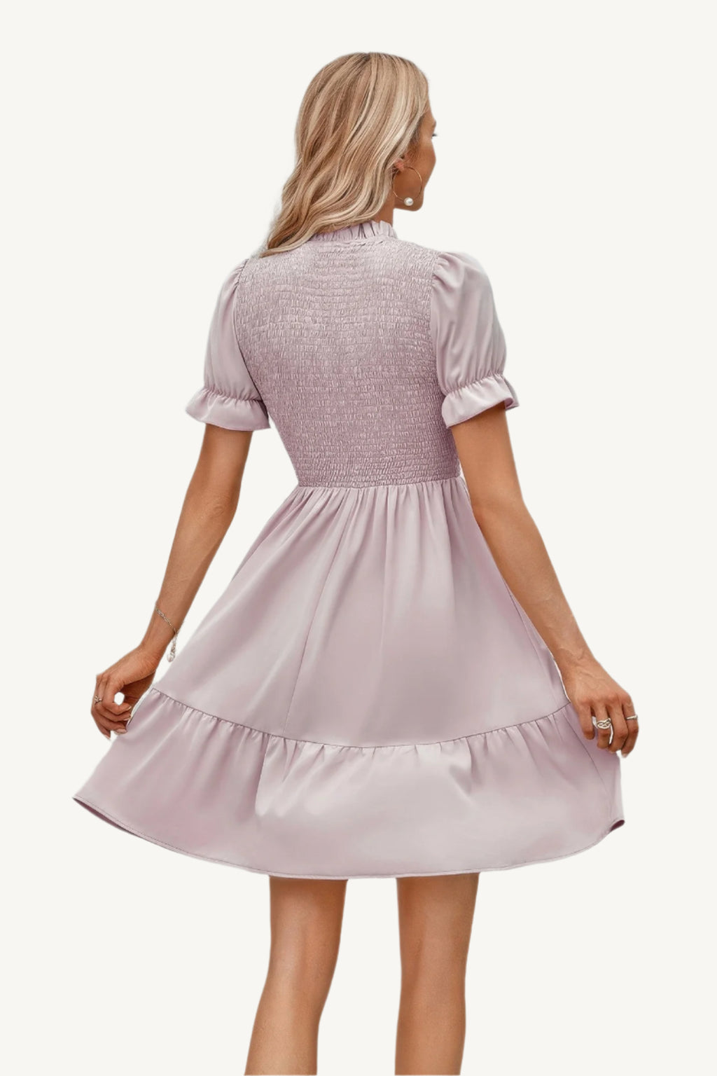 Solid puff sleeve dress with shirred bodice and ruffle hem, made from lightweight polyester – feminine, playful, and perfect for warm-weather days.