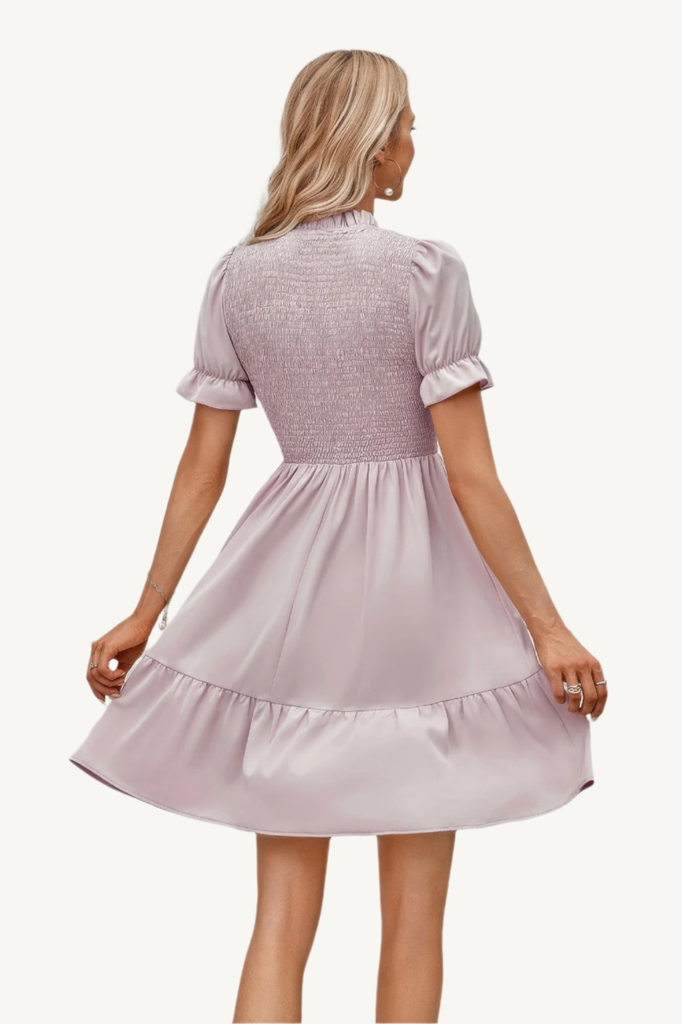 Solid puff sleeve dress with shirred bodice and ruffle hem, made from lightweight polyester – feminine, playful, and perfect for warm-weather days.