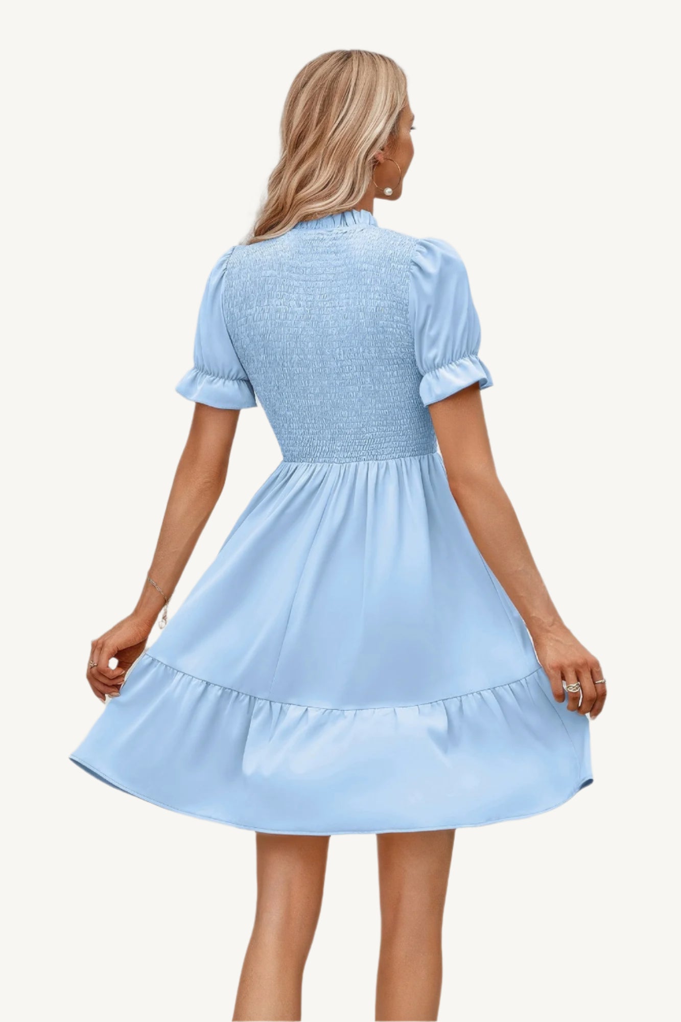 Solid puff sleeve dress with shirred bodice and ruffle hem, made from lightweight polyester – feminine, playful, and perfect for warm-weather days.