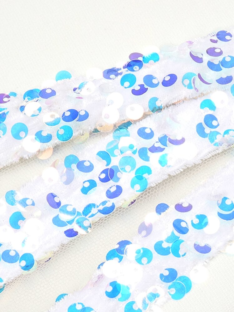 Close-up of blue and purple sequin fabric on a white background