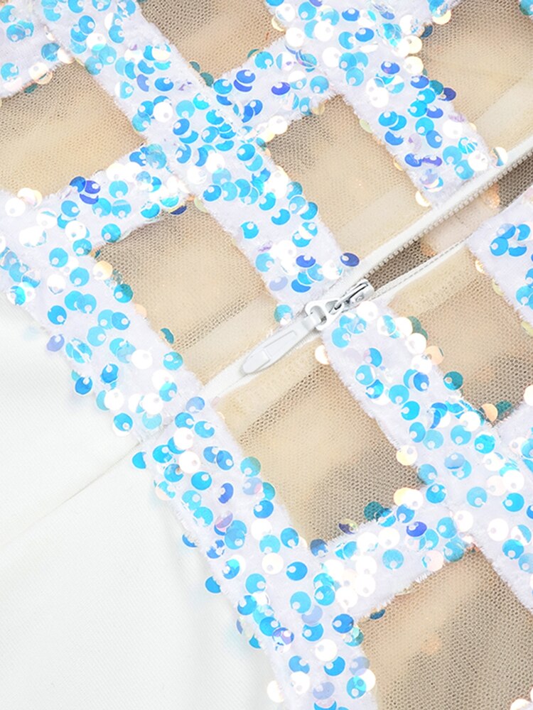 Close-up of a decorative mesh panel with blue and white beads on a beige background