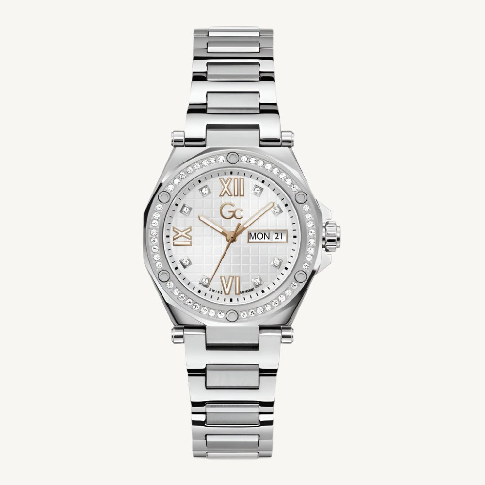 Stylish multifunctional ladies' silver-tone stainless steel watch with white dial, sapphire glass, stone-set case and face, featuring weekday and date display, water-resistant to 100 meters.