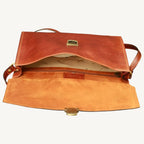 "Slim full-grain calfskin leather briefcase with lock and key closure, synthetic lining, and adjustable leather strap, perfect for modern professionals."