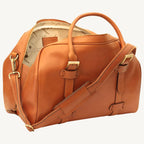 "Full-grain calfskin leather travel bag with synthetic lining, interior zip pocket, and padded adjustable strap – stylish and durable for travel"