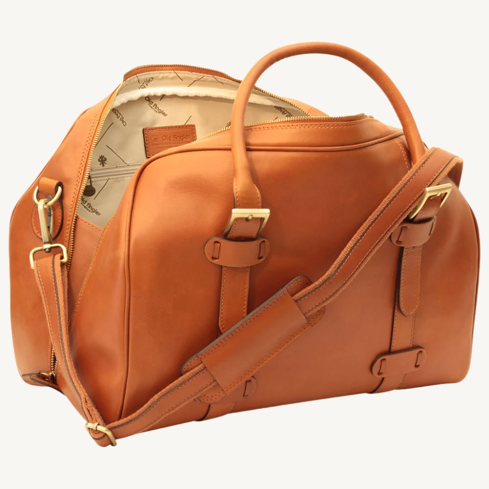 "Full-grain calfskin leather travel bag with synthetic lining, interior zip pocket, and padded adjustable strap – stylish and durable for travel"