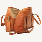 "Full-grain calfskin leather travel bag with synthetic lining, interior zip pocket, and padded adjustable strap – stylish and durable for travel"