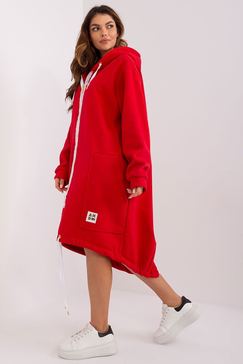 Woman wearing a red hoodie dress on a white background