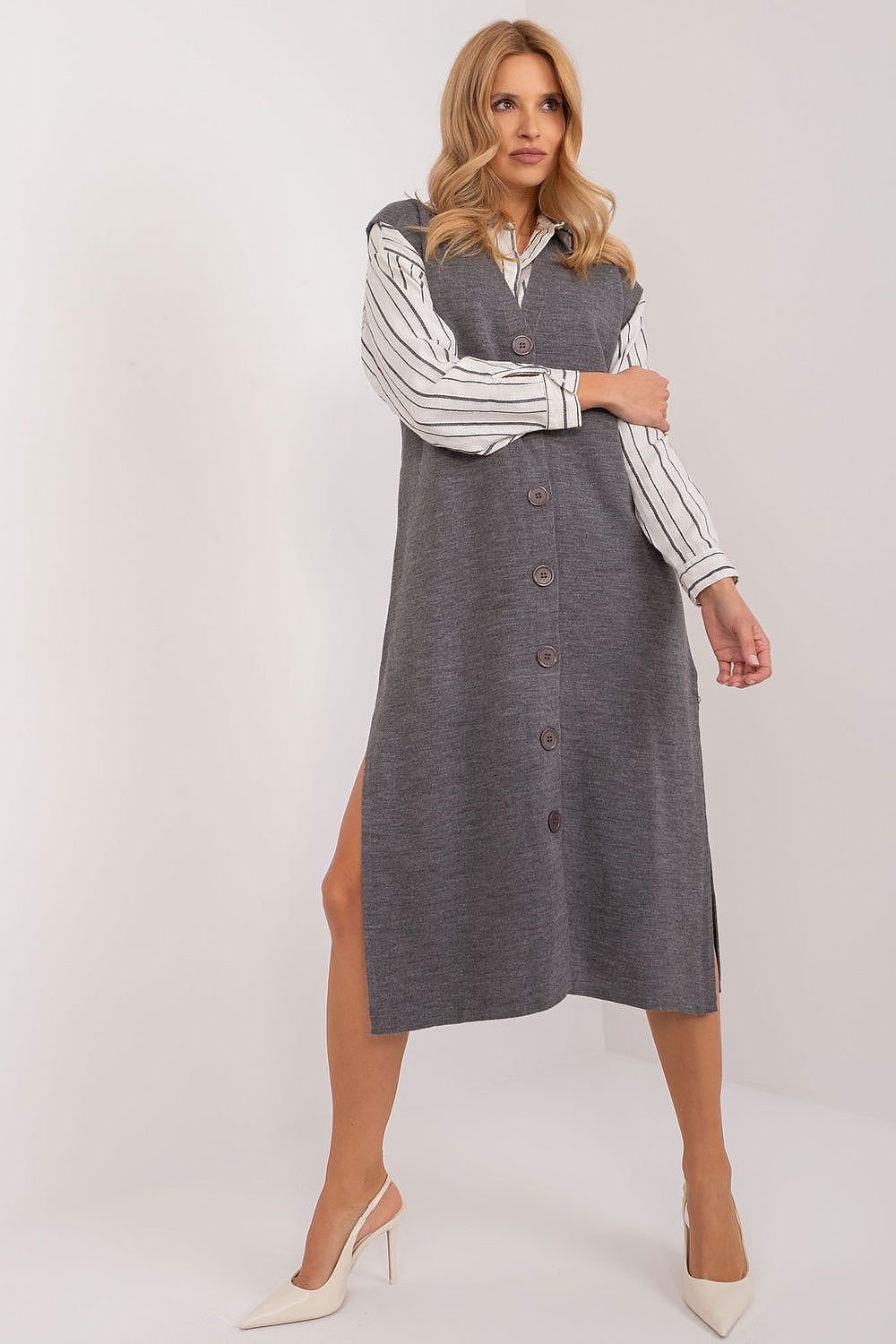 Woman wearing a gray dress with striped sleeves on a white background