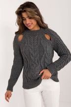 Woman wearing a gray cable knit sweater on a white background