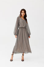 Woman wearing a patterned dress on a white background