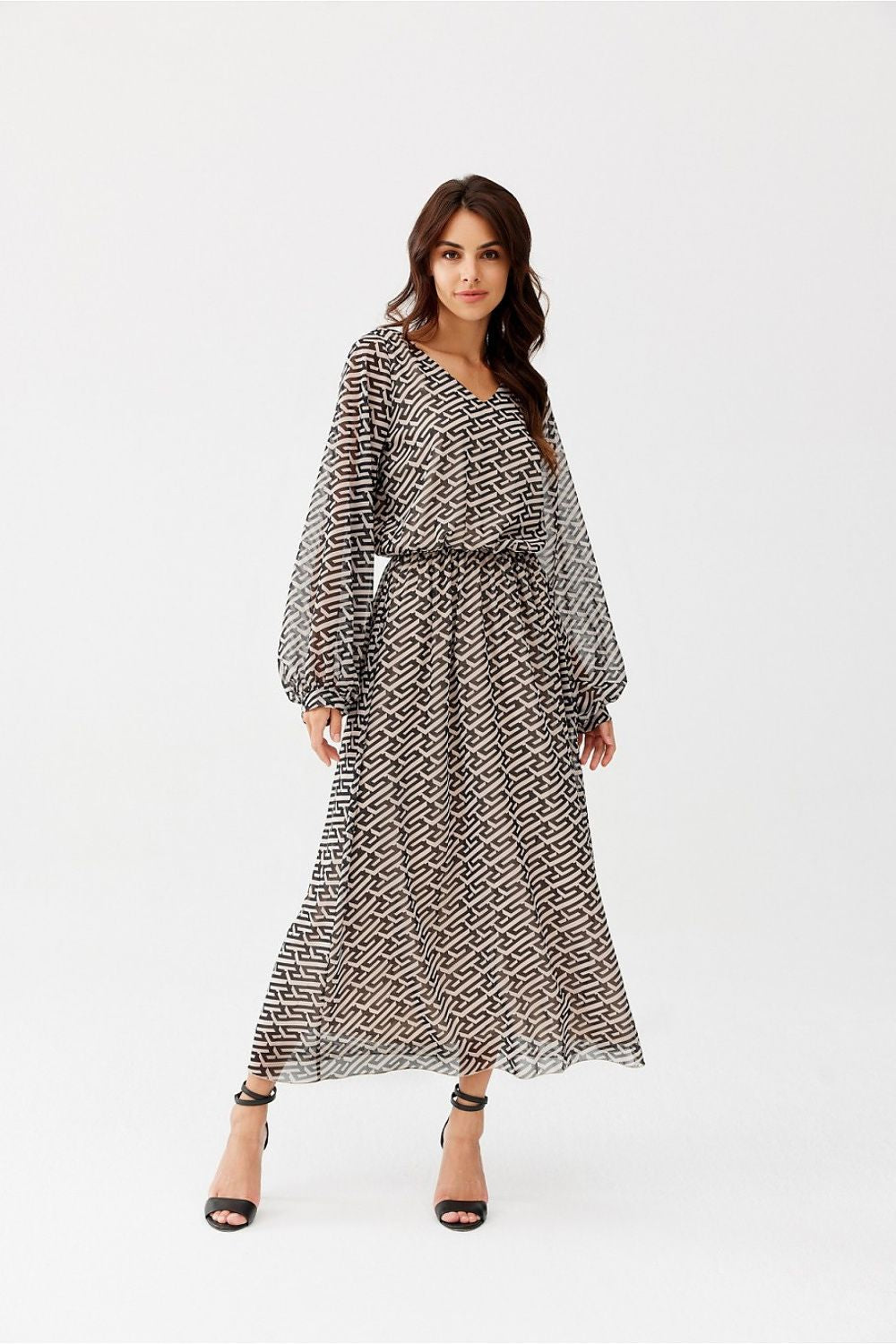 Woman wearing a patterned dress on a white background