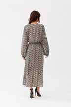 Woman wearing a patterned dress on a white background