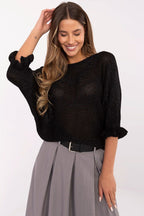 Woman wearing a black sweater and gray skirt on a white background