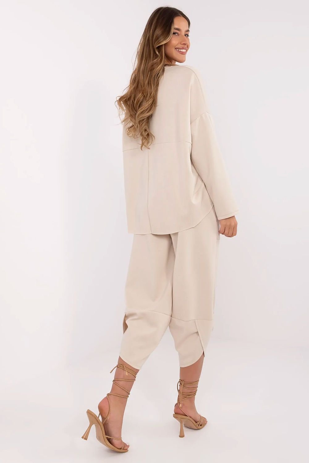 Woman wearing a beige suit on a white background