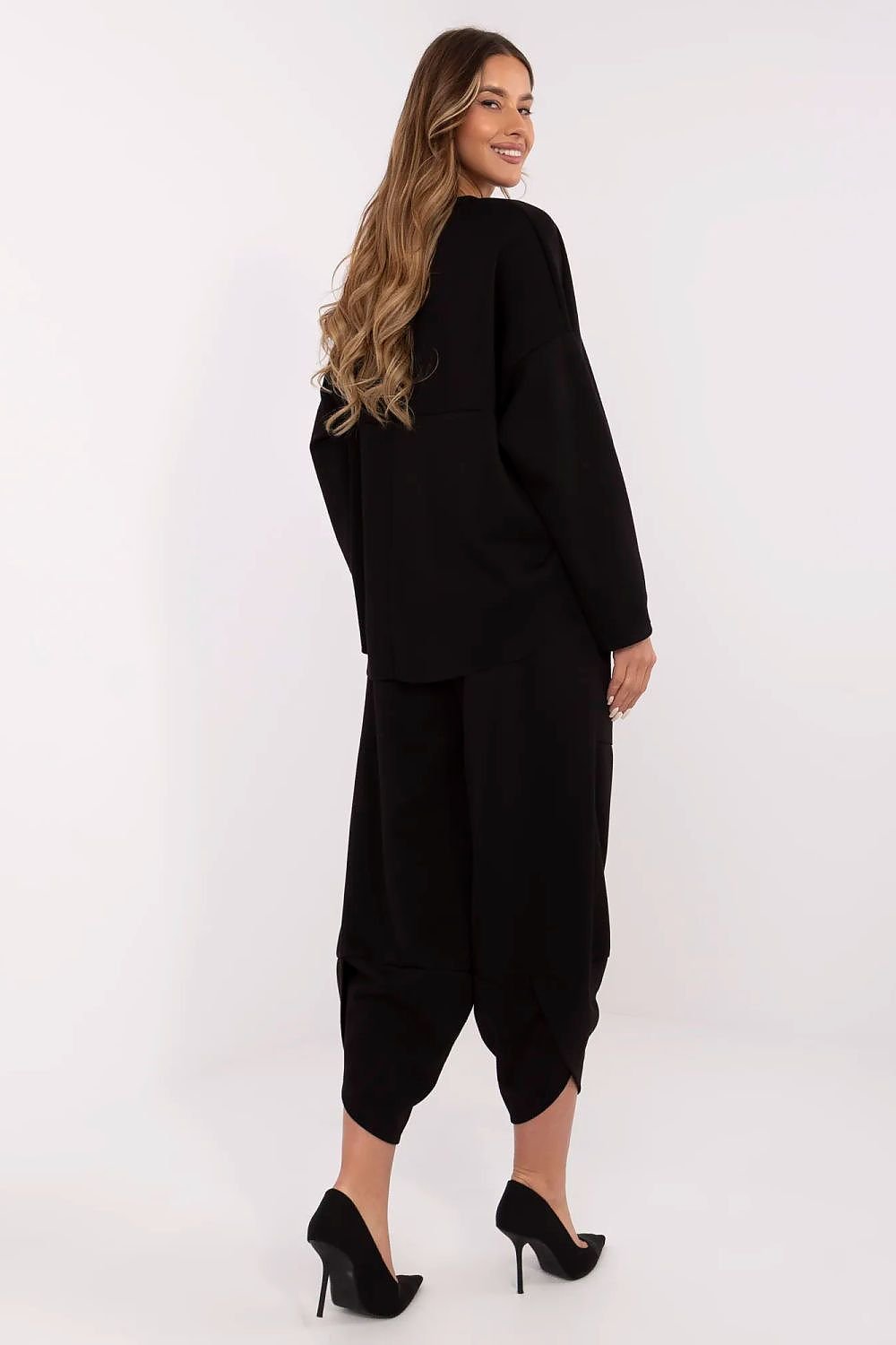 Woman wearing a black outfit with a white background