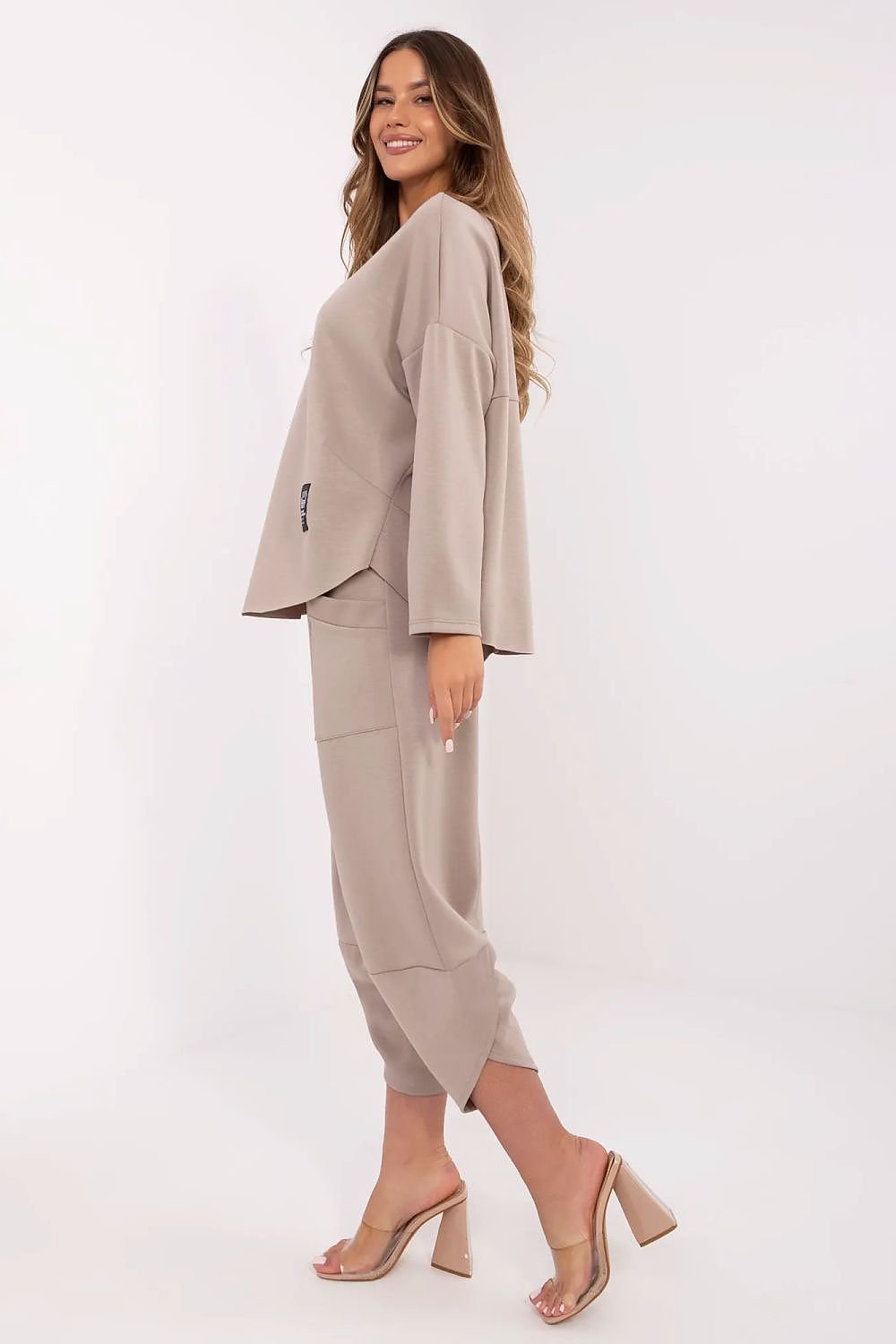 Woman wearing a beige suit on a white background