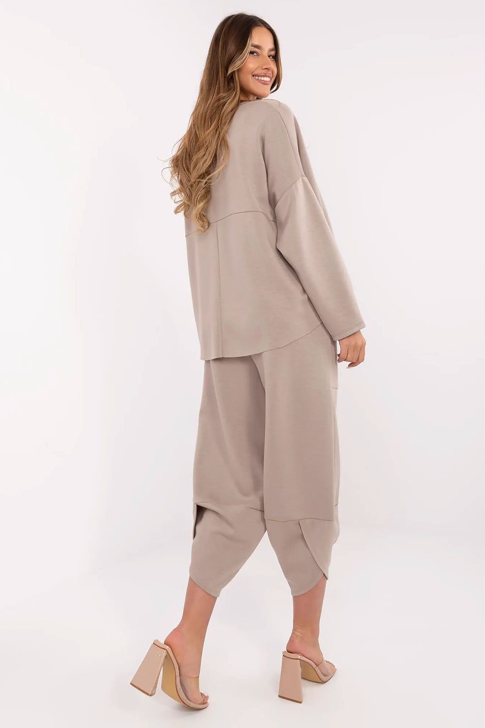 Woman wearing a beige outfit on a white background