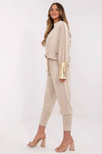 Woman wearing a beige outfit with a white background